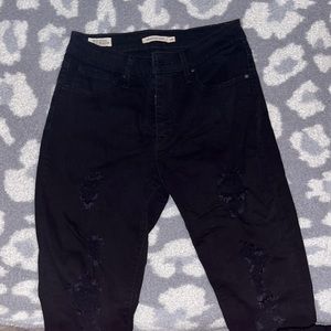 Black distressed high rise skinny jeans. Size 29.